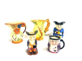 Selection of assorted jugs includes Bursleigh, toby jugs etc