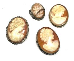 Four silver shell cameo brooches including marcasite (21g)