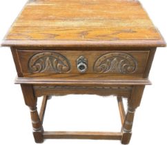Oak side table with carved drawer measures approx 26 inches tall by 21.5 inches wide and 17 inches