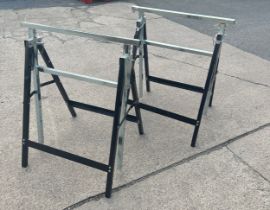 Pair of folding metal trestles adjustable height