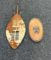 2 Carved African shields includes cow skin etc- Shield does have a crack as seen in pictures