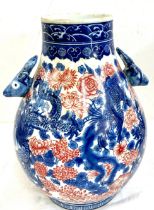 Oriental blue and white vase, red dragon detailing, overall height: 14 inches