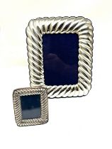 2 silver picture frames largest measures approx 20cm by 15cm