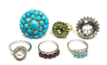 Six silver gemstone set dress rings including garnet and amethyst (30g)