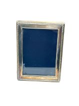 silver picture frame measures approx 16cm by 12cm