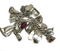 A vintage silver charm bracelet with assorted novelty charms (109g)