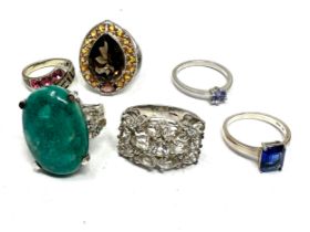Six silver gemstone set dress rings including tanzanite (32g)