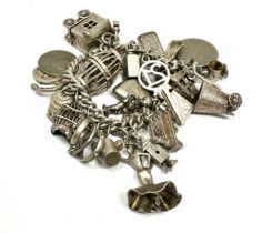 A vintage silver charm bracelet with assorted novelty charms (92g)