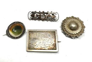 Four Victorian silver brooches including an operculum (25g)