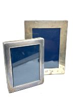 2 silver picture frames largest measures approx 20cm by 15cm