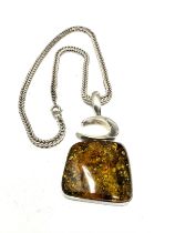 A silver amber pendant and chain (38g)