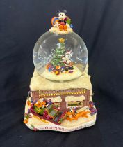 Disney the Merriest place on earth snow globe, plays tune we wish you a merry Christmas, boxed