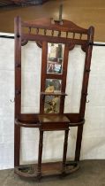 Mahogany mirror back hall stand measures approximately 77 inces tall 36 inches wide 11 inches depth