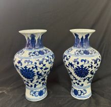 Pair of blue and white oriental vases height approximately 12 inches