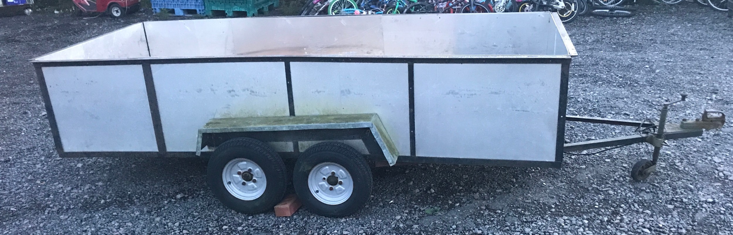 Twin axle trailer with sides, 129.5 inches in length, Width 56 inches, overall length with crow