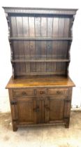 Oak three drawer two door dresser with panel sides measures approx 67 inches tall by 36 inches