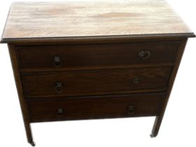 3 Drawer oak chest of drawers on casters measures approximately 32 inches tall 35 inches wide 17