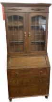 Glazed oak bureau bookcase, two door, top with flared cornice, leaded doors with three drawers