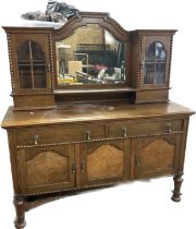 Oak mirror back sideboard flanked by two cupboards measures approx height 72 inches by 67 inches