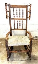 Antique rocking chair with spindle back and sides with recenty new rush sitting