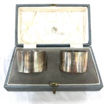 Cased silver hallmarked napkin rings (not a pair), total silver weight 64.6g