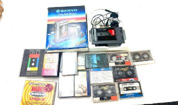 Boxed Sanyo vintage walkman, model M-G27ASP together with a selection of cassettes, untested