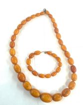 Antique egg yolk amber bead necklace and bracelet with internal streaking total weight 82grams