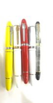 5 Jinhao pens in red, yellow, white and a grey marble