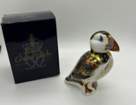 A Royal Crown Derby paperweight, Puffin, gold stopper and red Royal Crown Derby stamp on the base,
