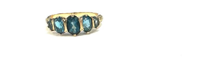 9ct gold ting with london blue topaz stones unmarked but tested 9ct size R weight 3.2 grams