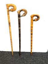 Three vintage carved handled walking sticks