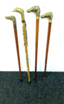 Selection of vintage wooden walking sticks with brass handles includes horse, dog, dolphin etc