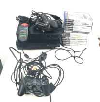 2 x Play station 2s and a playstation 1 console, 5 controllers and a selection of assorted games,