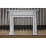 A George III painted pine fire surround in the style of Robert Adam,