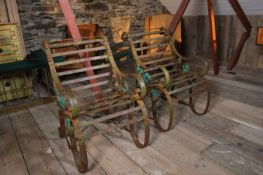 A pair of iron strapwork garden chairs,