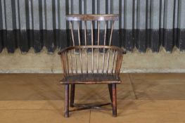 An elm and beech child's comb-back Windsor armchair,
