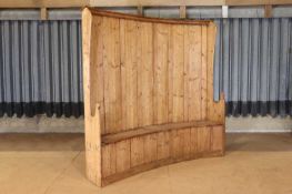 A curved pine settle,