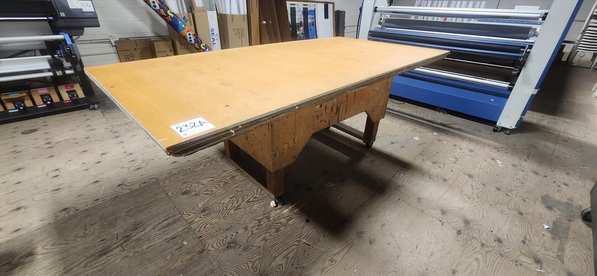 wooden table w/ casters, approx. 48 in. x 96 in. (excluding contents)