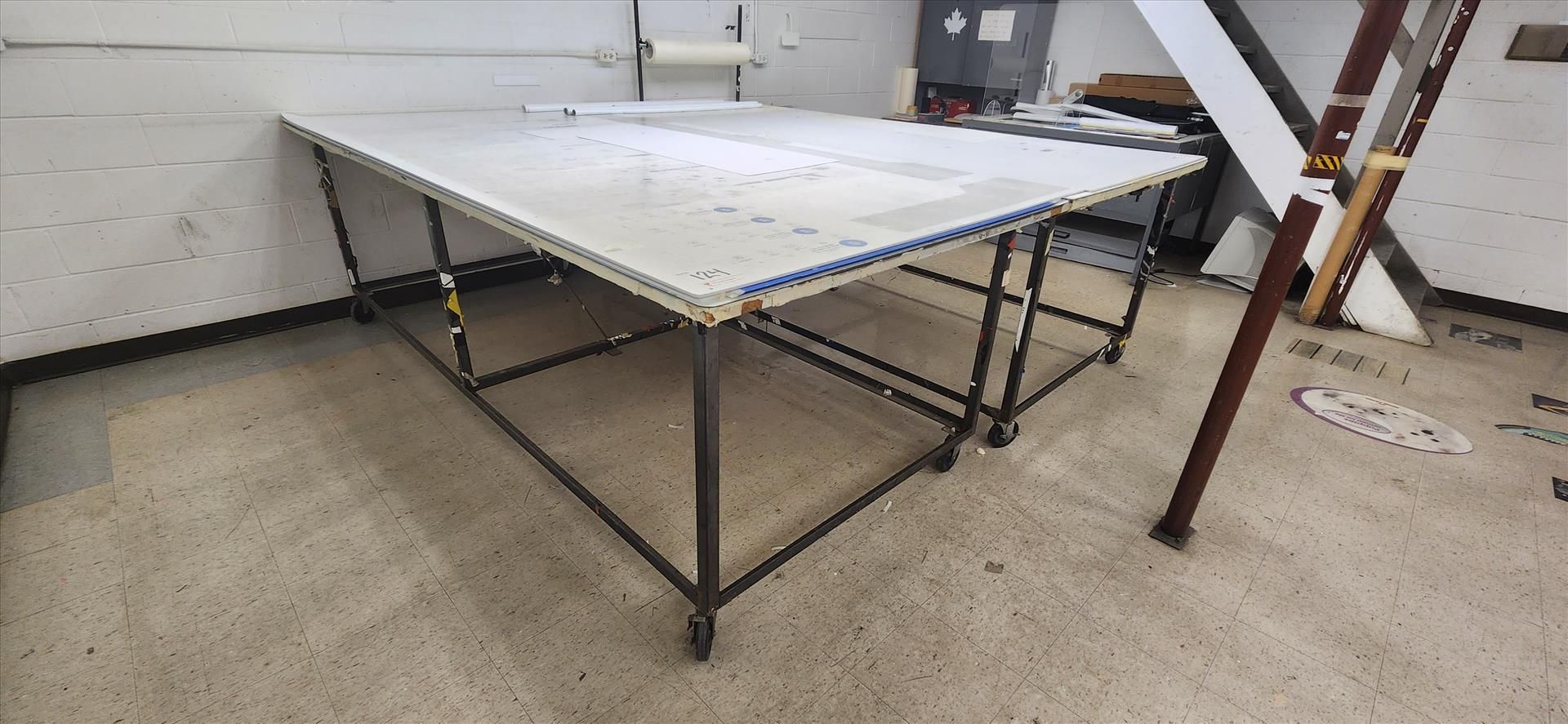 trim table w/ metal frame and casters, approx. 54 in. x 121 in. (excluding contents)