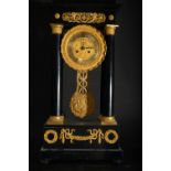 Portico-type Empire Clock in Gilded Bronze and ebonized wood, 19th century