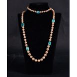 Necklace of pearls and turquoise faience of Egyptian jewelry with scarabs