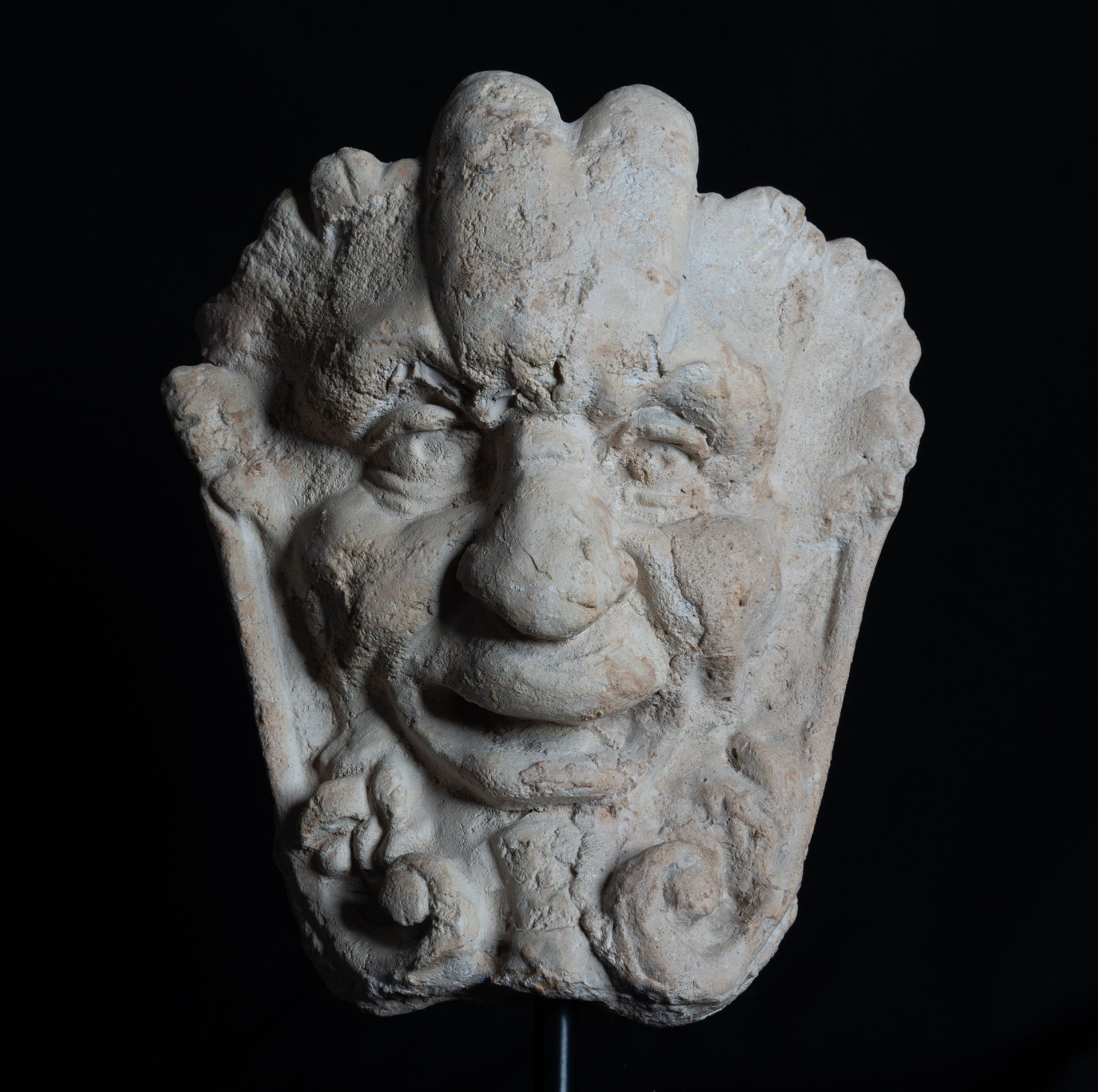 Decorative Head of Faun in carved limestone, French work of the 18th century