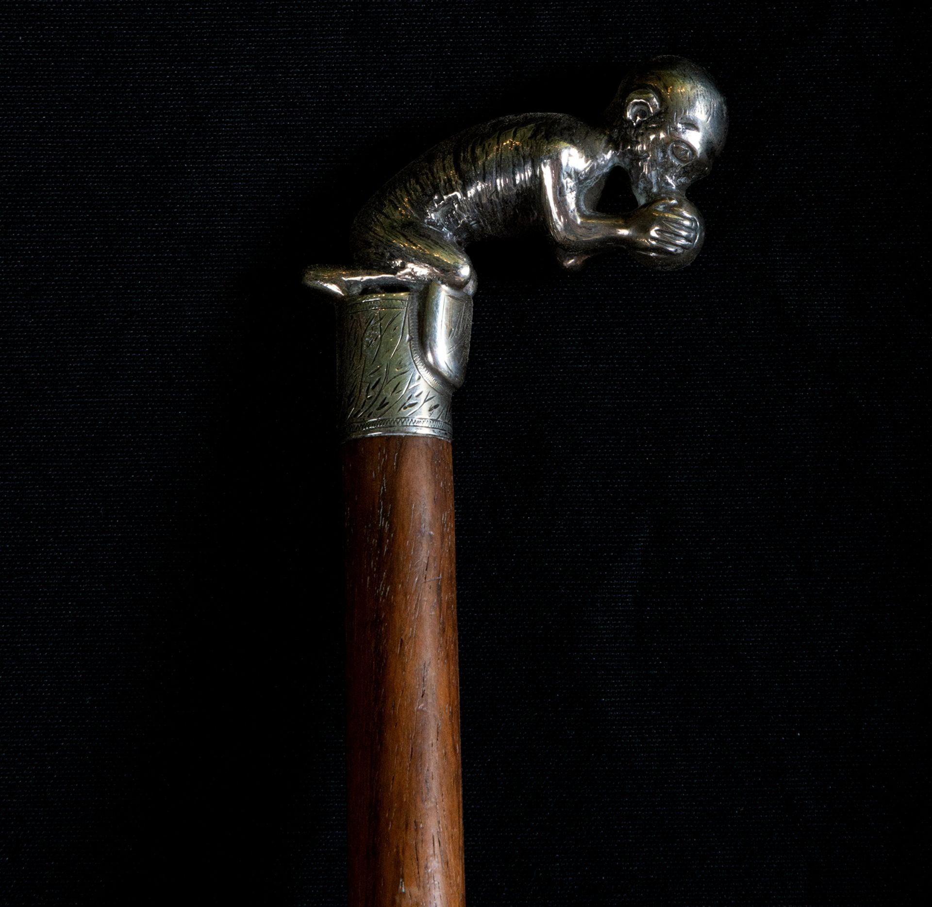 Colonial Jamaican walking stick with monkey handle and heraldic shield, 19th century