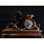 Elegant table clock with Cupid in gilt and patinated bronze on a red marble base, 19th century