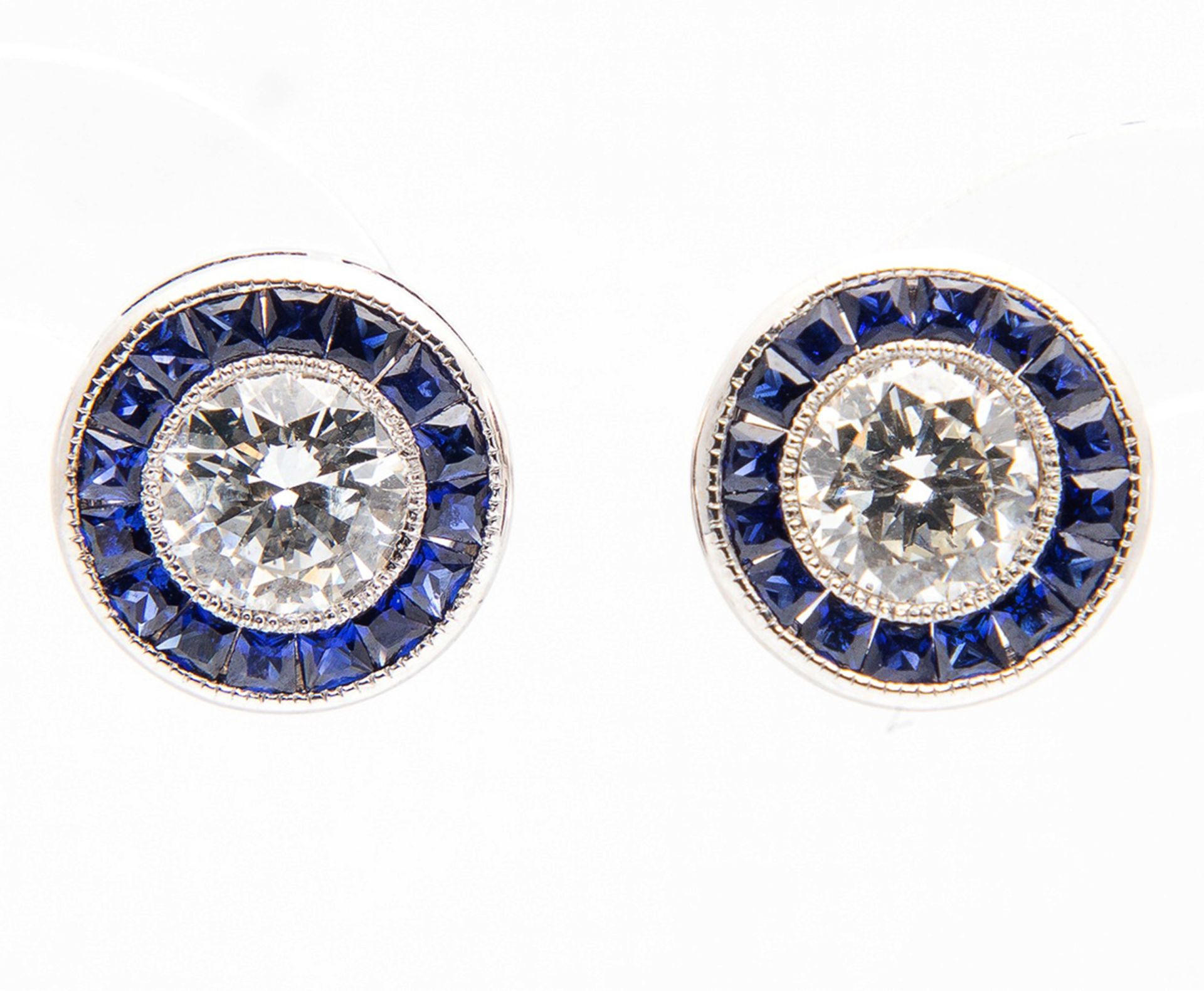 Elegant 1920s earrings with two 0.50 ct Diamonds each edged with sapphires, very good purity and col