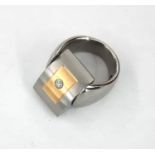 Elegant rocker ring in steel and gold with a central diamond
