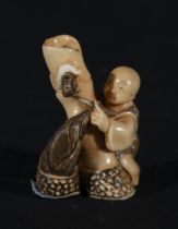 Japanese Netsuke on Mammoth Tusk (Mammuthus primigenius) representing Child with Snail, 19th century