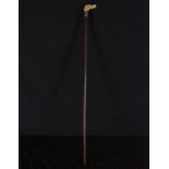 Victorian cane in ebony with embossed silver handle with dog's head carved in deer antler, 19th cent