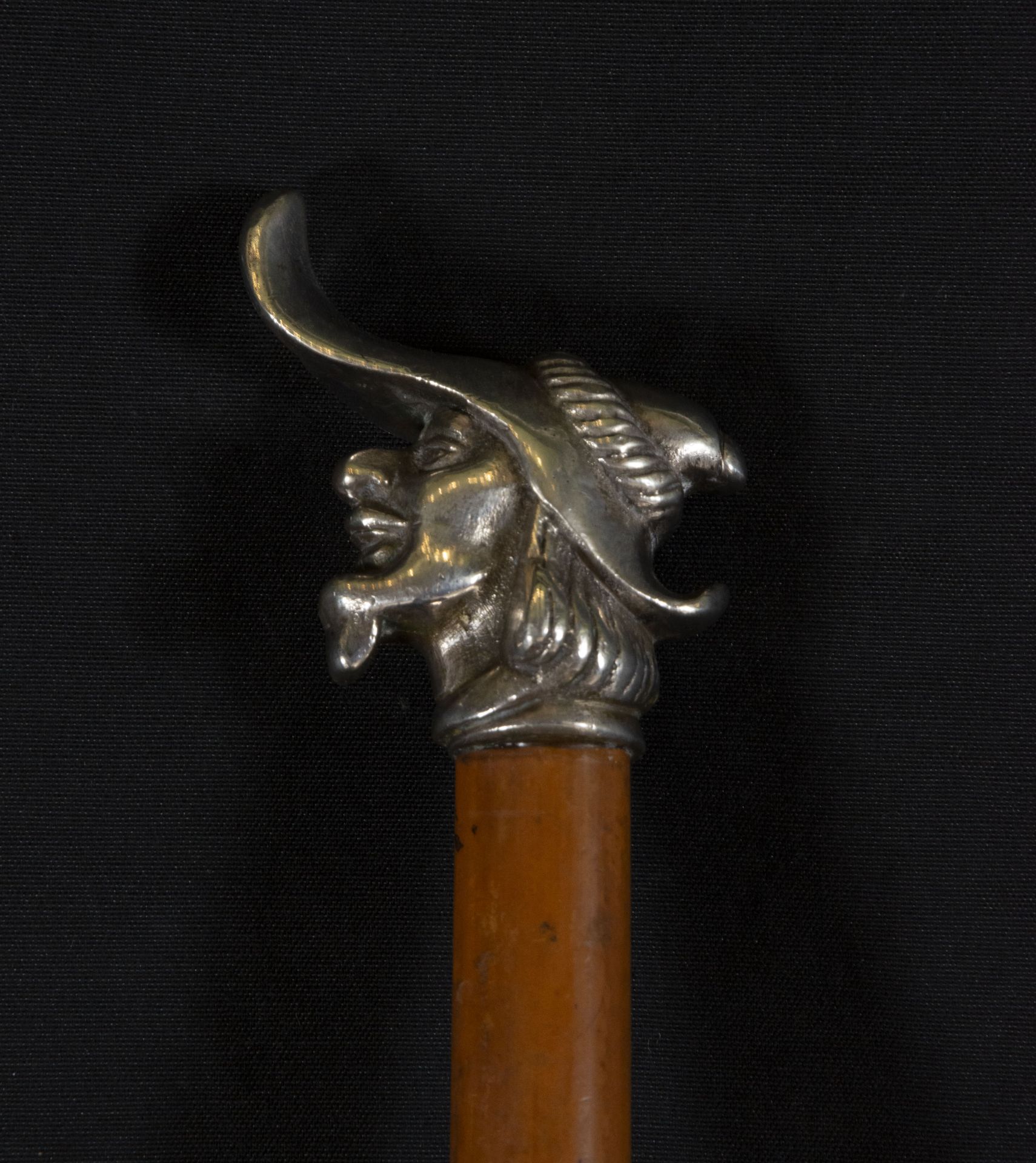 French cane, made of tropical wood and embossed silver head in the shape of a trobador's head, 19th 