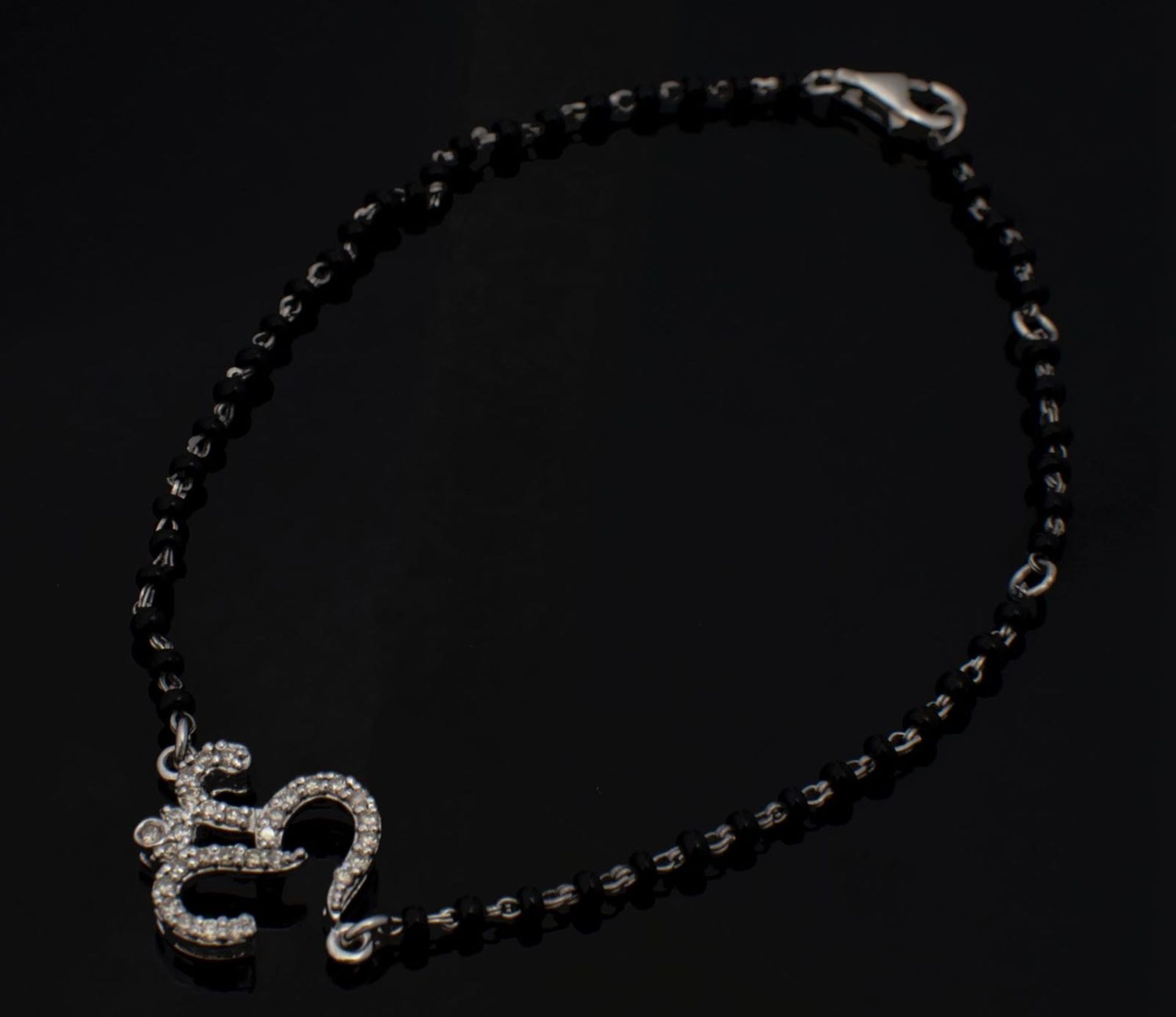 “Oṃ” Bracelet White Gold, Silver and Diamonds.